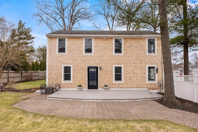 back of house featuring a yard, fence private yard, and a patio area