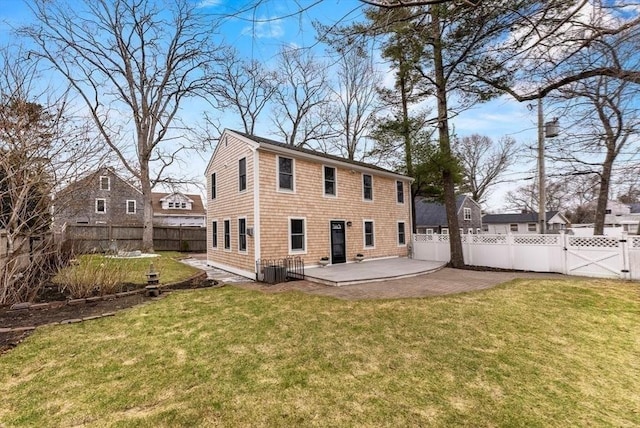 back of property with a fenced backyard, a lawn, a gate, and a patio
