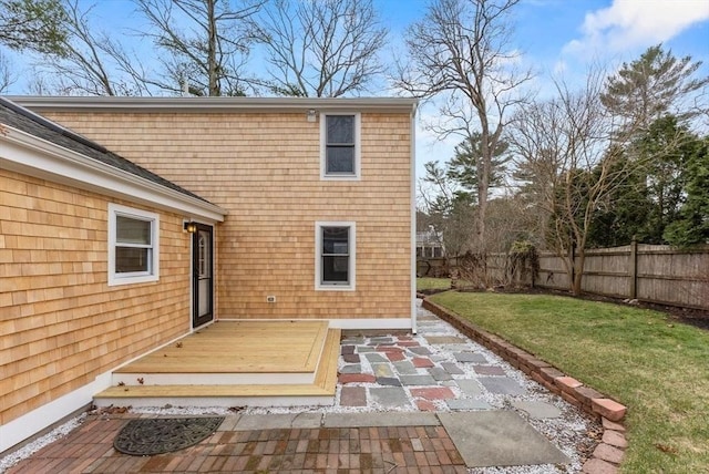 exterior space with a lawn, fence, a deck, and a patio area