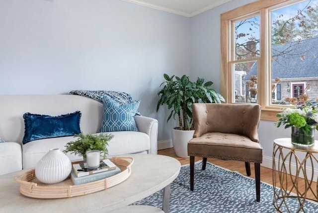 sitting room featuring crown molding, baseboards, and wood finished floors