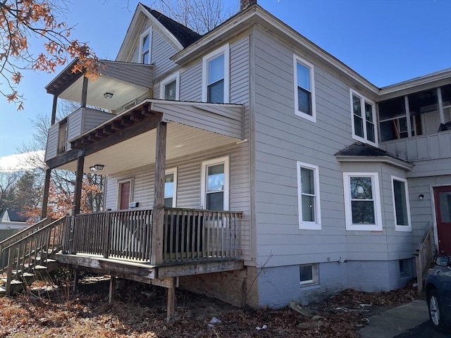 view of side of property with covered porch