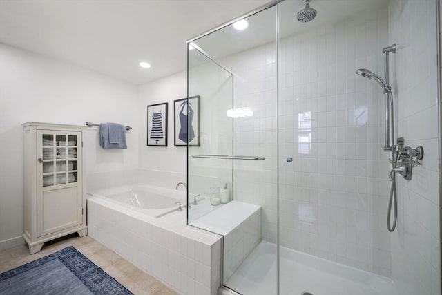 bathroom featuring tile patterned flooring and shower with separate bathtub