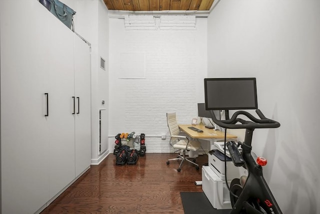 office area featuring brick wall, wooden ceiling, and dark hardwood / wood-style flooring