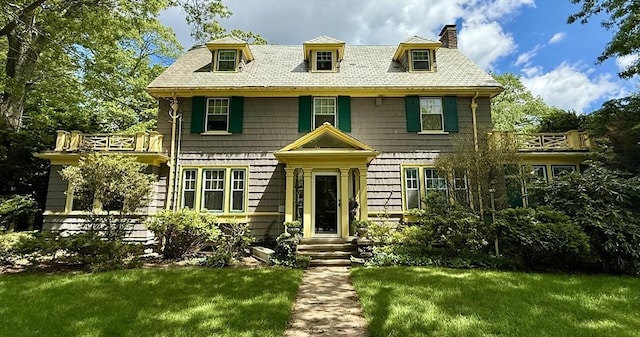 117 Fuller St, Newton, MA 02465 - view of front of house featuring a chimney, a front yard, and a balcony