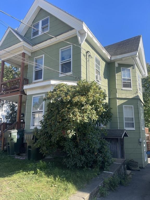 view of side of home featuring a lawn