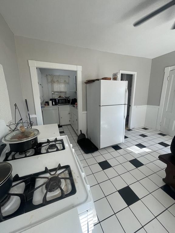 kitchen featuring white cabinetry and white appliances