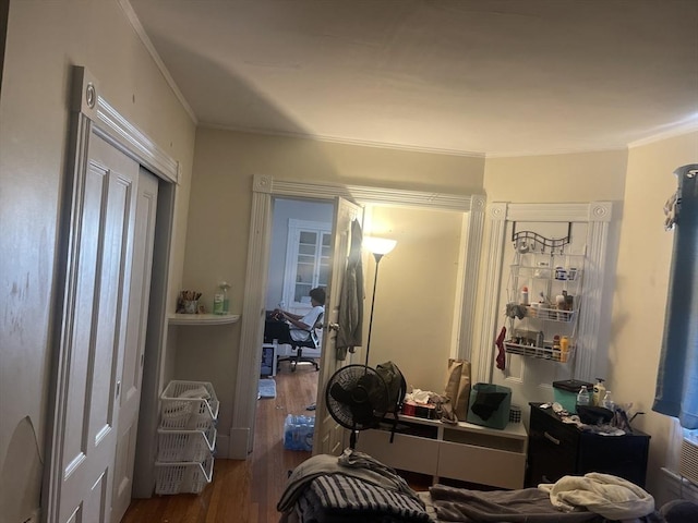 interior space featuring a closet, hardwood / wood-style floors, and ornamental molding