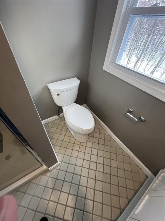 bathroom with toilet and tile patterned floors