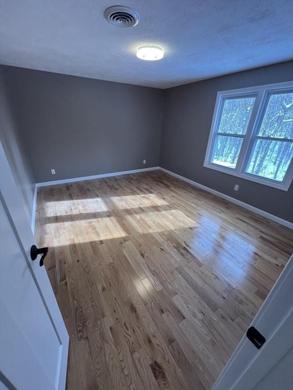 unfurnished room featuring light hardwood / wood-style floors