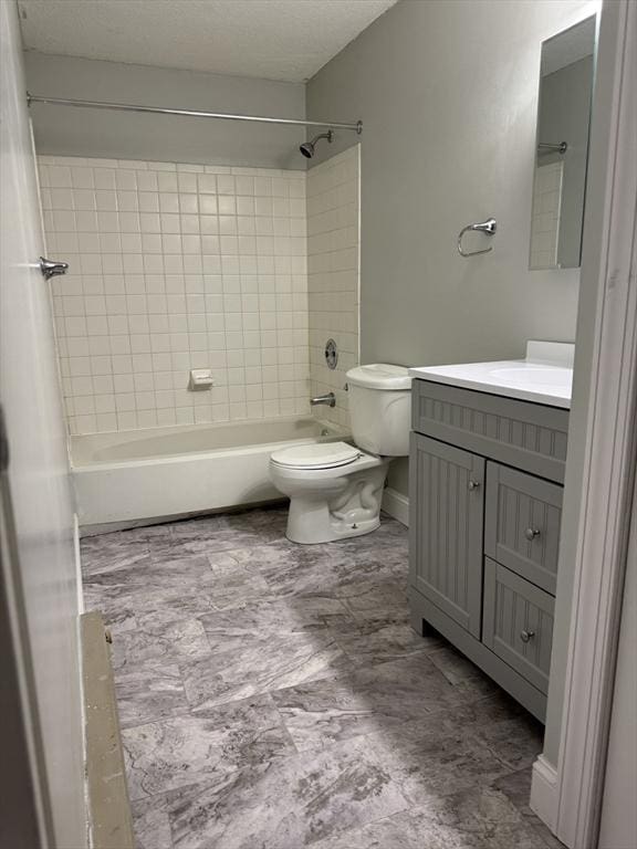 full bath with shower / tub combination, a textured ceiling, toilet, and vanity