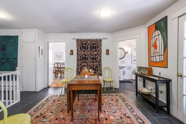 dining room featuring dark tile patterned flooring