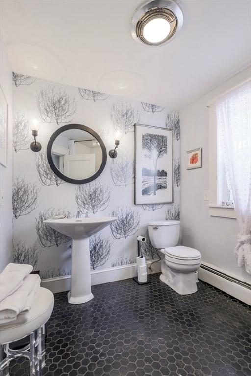 bathroom featuring toilet and a baseboard radiator