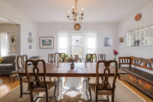 dining room with an inviting chandelier and hardwood / wood-style flooring