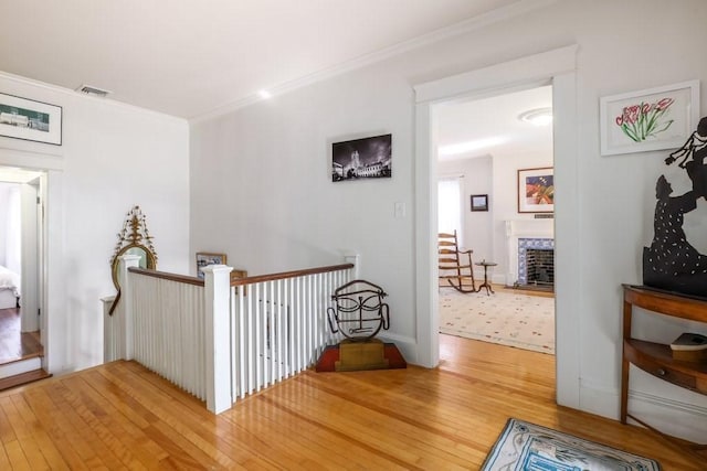 corridor featuring hardwood / wood-style flooring and crown molding