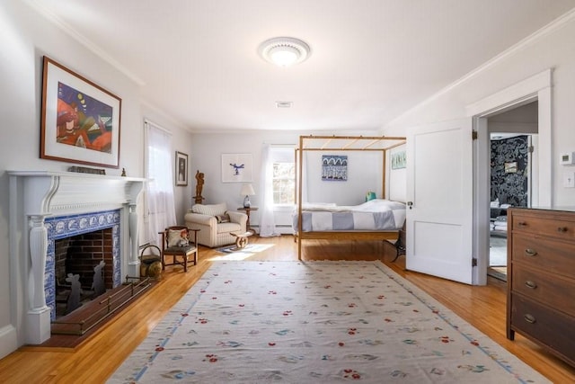 interior space featuring crown molding, a baseboard radiator, and hardwood / wood-style flooring