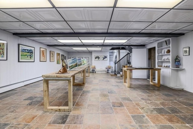 basement featuring baseboard heating and built in shelves