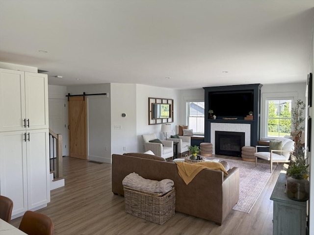 LOT1 Jeffrey Ln, West Bridgewater, MA 02379 - living area featuring a barn door, light wood-style flooring, and a fireplace