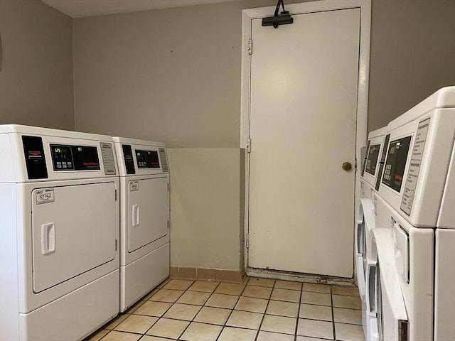 clothes washing area featuring stacked washing maching and dryer, light tile patterned floors, a mail area, and separate washer and dryer