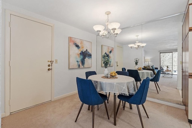 dining room with light colored carpet and a notable chandelier