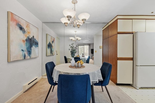 dining area featuring an inviting chandelier and baseboard heating