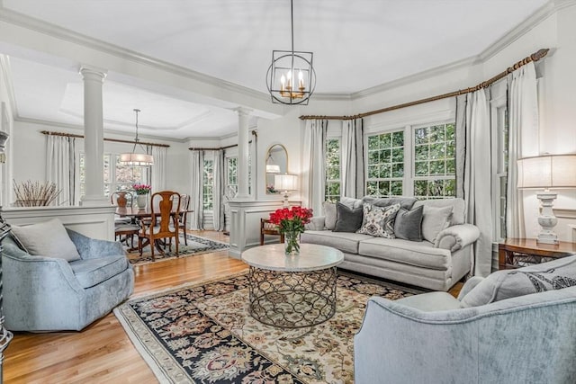 14 Glen Rd, Hopkinton, MA 01748 - living room featuring ornate columns, a chandelier, crown molding, light wood-style floors, and plenty of natural light