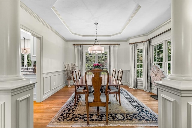 14 Glen Rd, Hopkinton, MA 01748 - dining room with light wood-type flooring, decorative columns, a decorative wall, a raised ceiling, and wainscoting