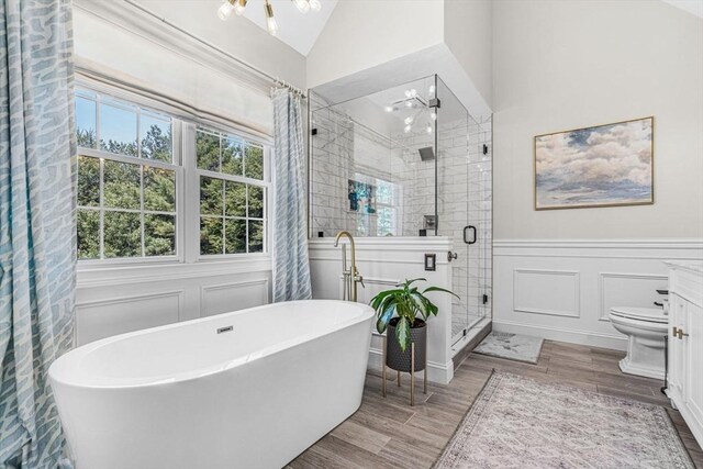 14 Glen Rd, Hopkinton, MA 01748 - bathroom with a freestanding tub, a stall shower, wood finished floors, a wainscoted wall, and vaulted ceiling