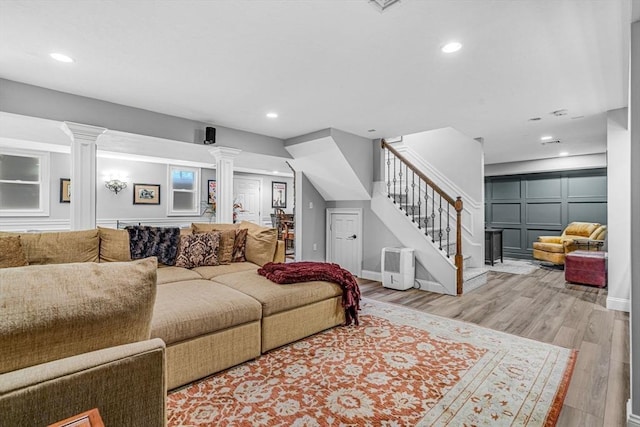 14 Glen Rd, Hopkinton, MA 01748 - living area featuring decorative columns, stairs, a decorative wall, wood finished floors, and recessed lighting
