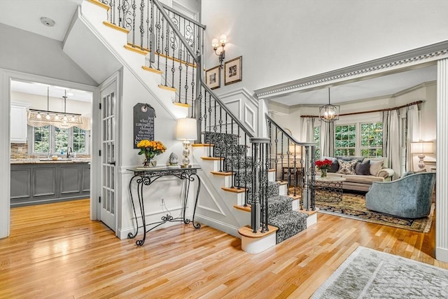 14 Glen Rd, Hopkinton, MA 01748 - stairway with a chandelier, plenty of natural light, wood finished floors, and a high ceiling