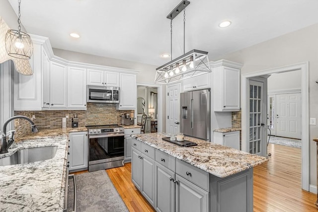 14 Glen Rd, Hopkinton, MA 01748 - kitchen with appliances with stainless steel finishes, gray cabinets, backsplash, a kitchen island, and recessed lighting