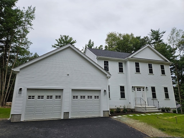 view of front of property featuring a garage and a front yard