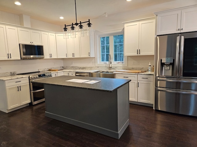 kitchen with stainless steel appliances, white cabinets, and dark hardwood / wood-style flooring