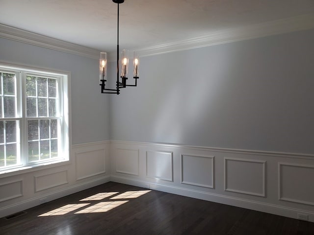 unfurnished dining area with crown molding, dark hardwood / wood-style flooring, a chandelier, and a wealth of natural light