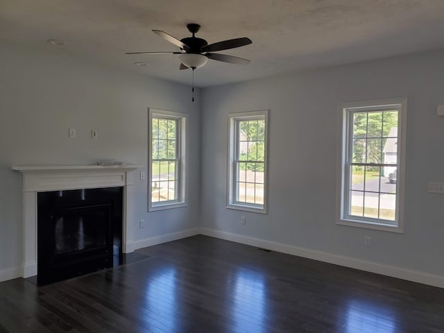 unfurnished living room with ceiling fan and dark hardwood / wood-style floors