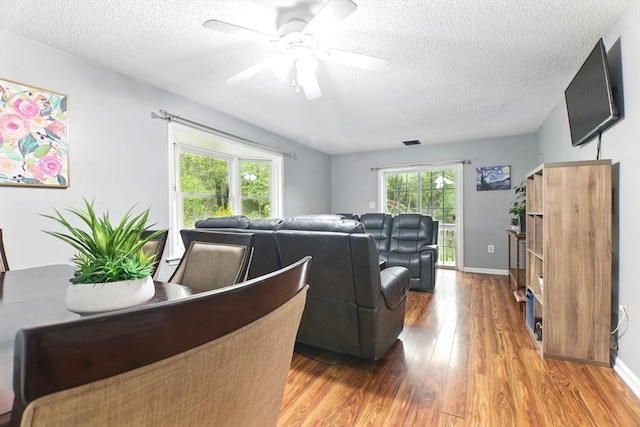 59 Castlegate Dr Unit B, Springfield, MA 01129 - living room featuring wood finished floors, a textured ceiling, a ceiling fan, and baseboards