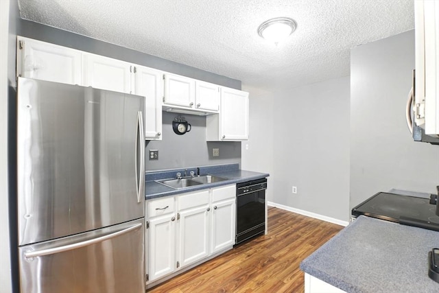 59 Castlegate Dr Unit B, Springfield, MA 01129 - kitchen featuring freestanding refrigerator, black dishwasher, a sink, dark countertops, and wood finished floors