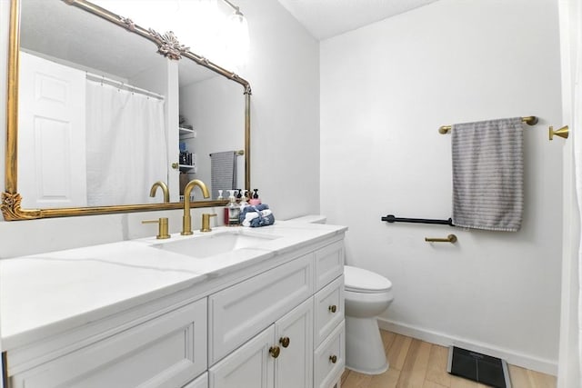 59 Castlegate Dr Unit B, Springfield, MA 01129 - bathroom with vanity, toilet, wood finished floors, and baseboards