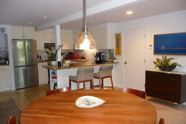 dining area with light hardwood / wood-style floors