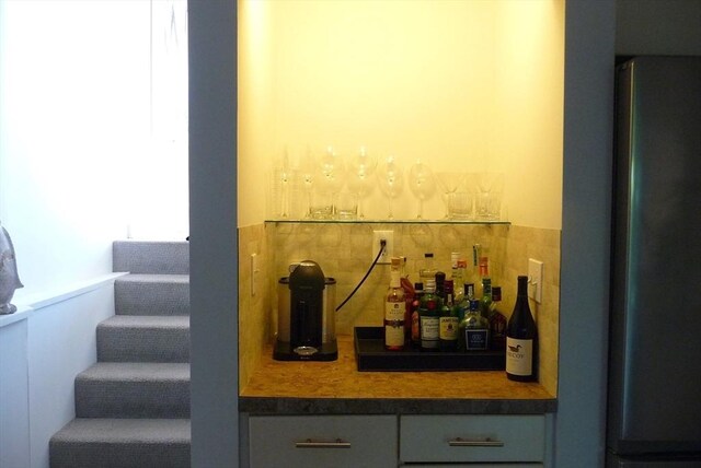 bar featuring stainless steel refrigerator