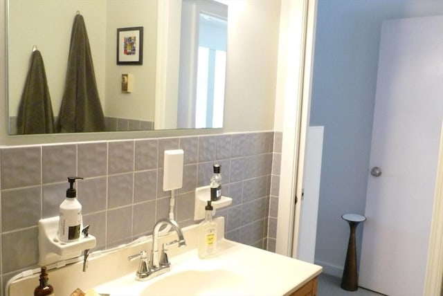 bathroom featuring vanity and tasteful backsplash