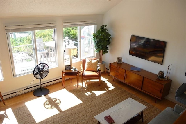 sitting room with wood-type flooring and a baseboard radiator