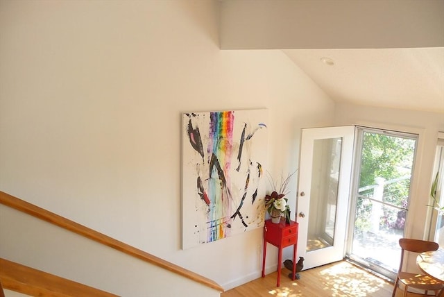 interior space with wood-type flooring and vaulted ceiling