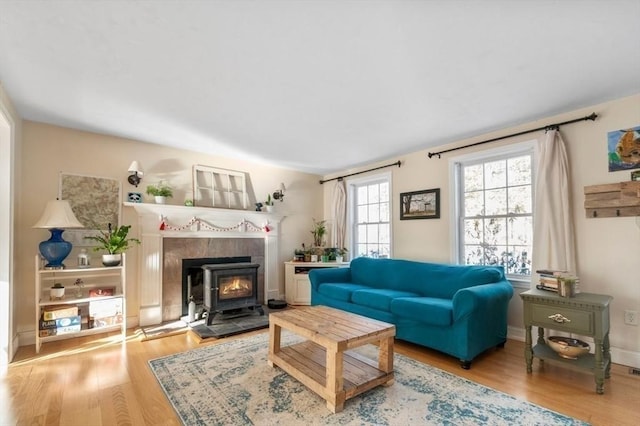 living area featuring baseboards and wood finished floors
