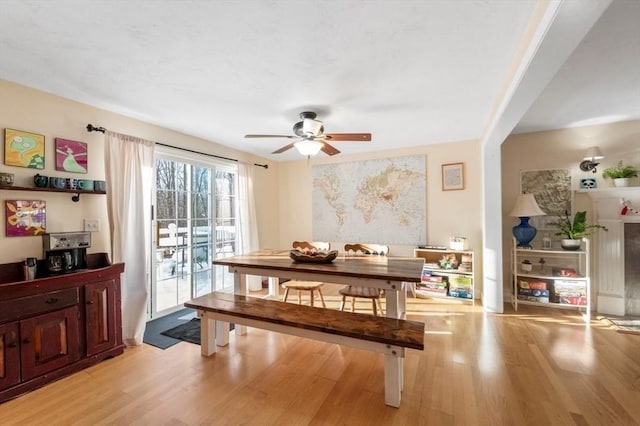 dining room featuring light wood-style flooring and a ceiling fan
