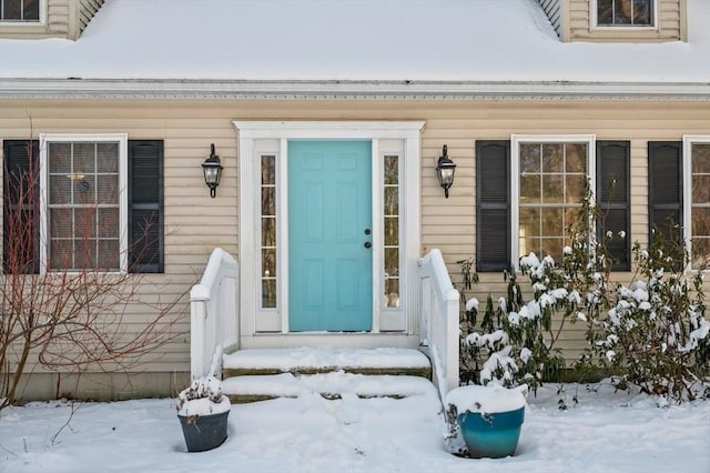 view of snow covered property entrance