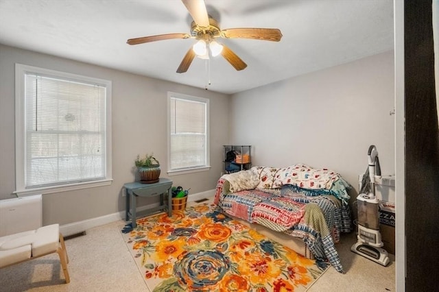 bedroom featuring baseboards, carpet floors, visible vents, and a ceiling fan