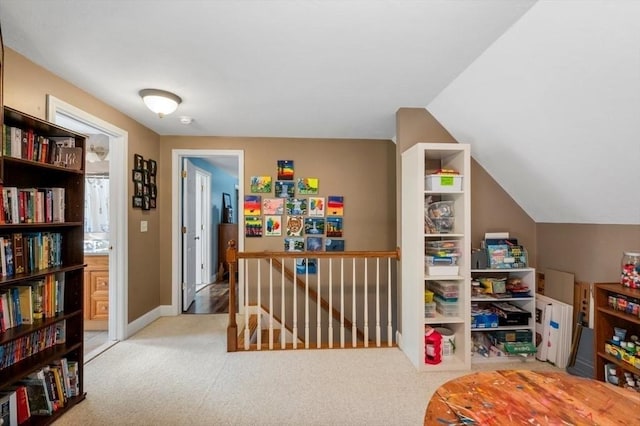 recreation room featuring baseboards, lofted ceiling, and carpet floors