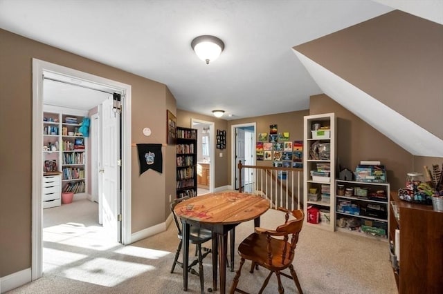 carpeted dining area featuring baseboards