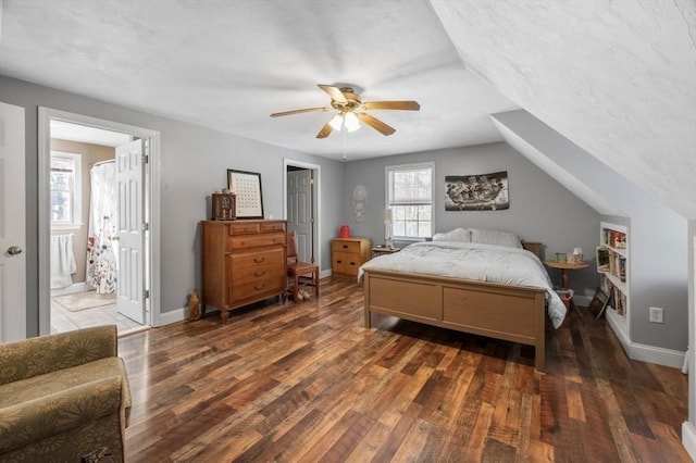 bedroom featuring vaulted ceiling, baseboards, a textured ceiling, ceiling fan, and wood finished floors