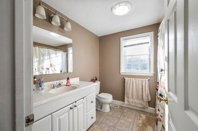 full bath with toilet, vanity, tile patterned flooring, baseboards, and visible vents